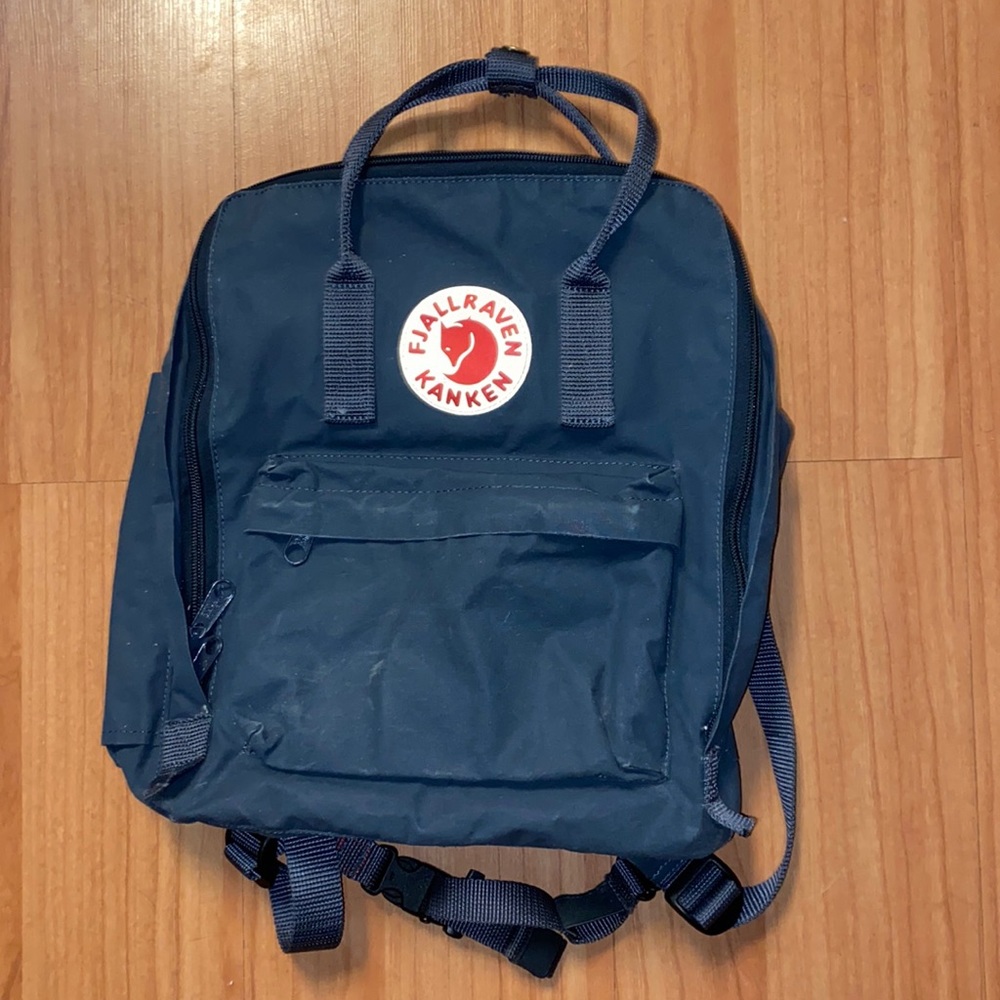 Fjallraven Kanken bags, navy blue and mustard yellow.